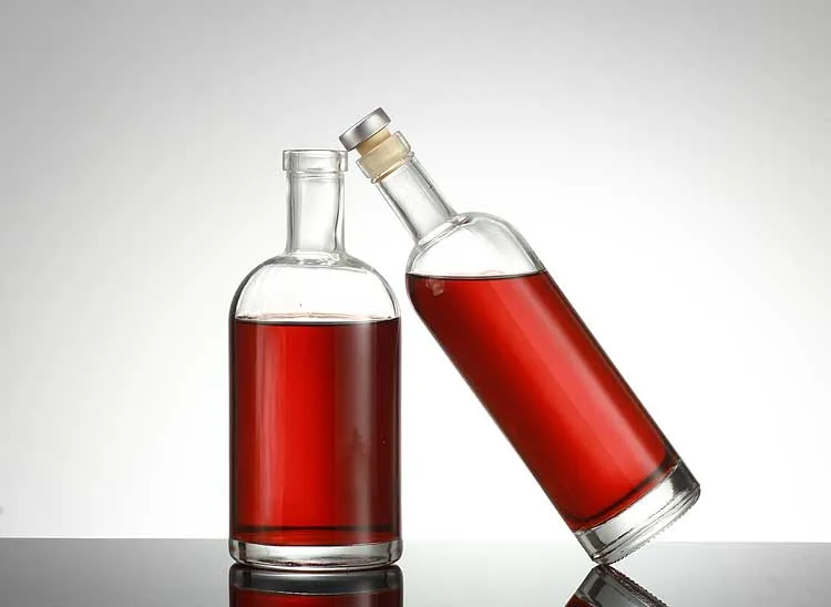 Two glass bottles with red liquid used as a packaging project visual reference